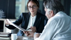 An attorney reviewing paperwork with her client.