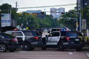 Police officers and patrol cars in an urban setting.