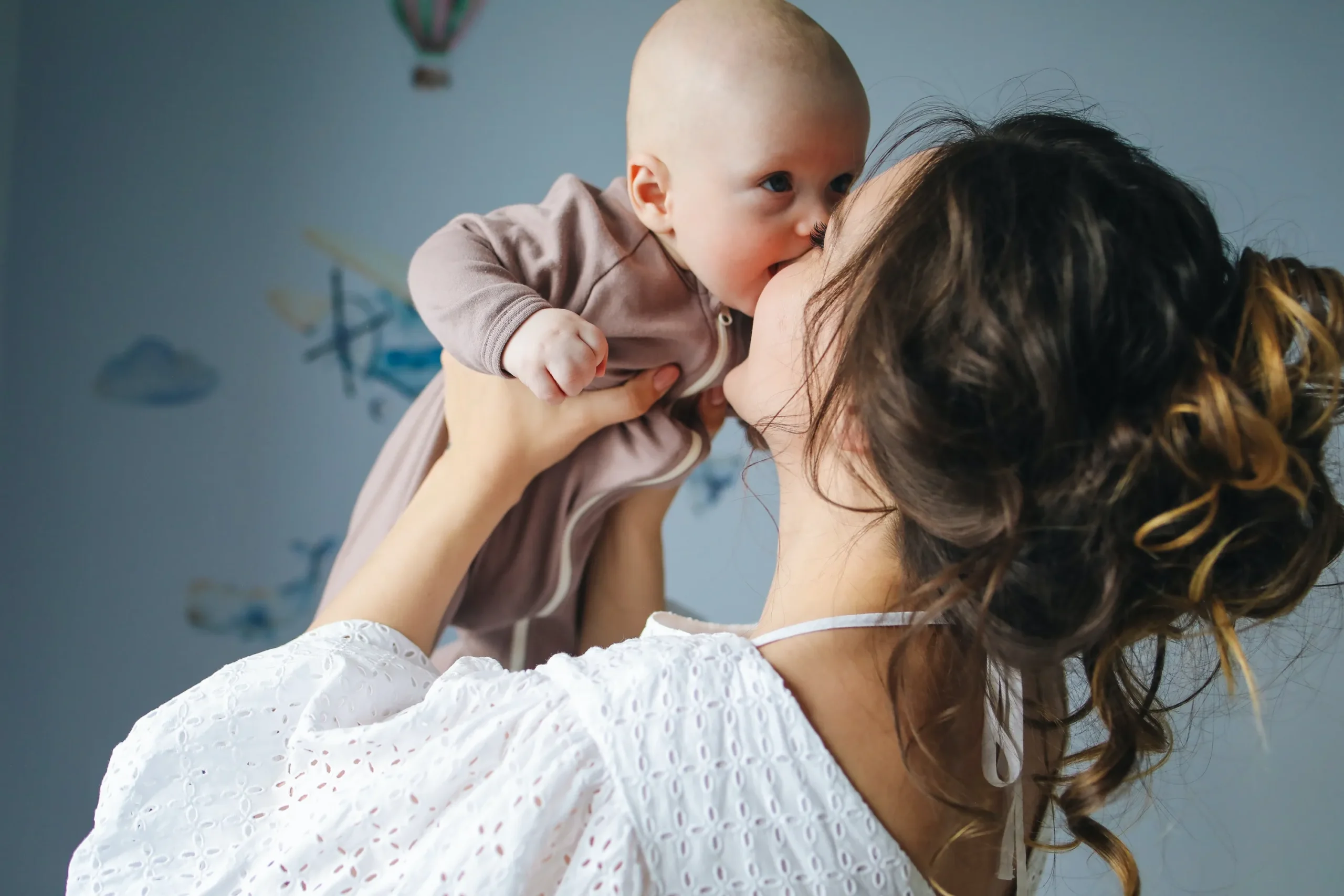 Woman kissing a baby.