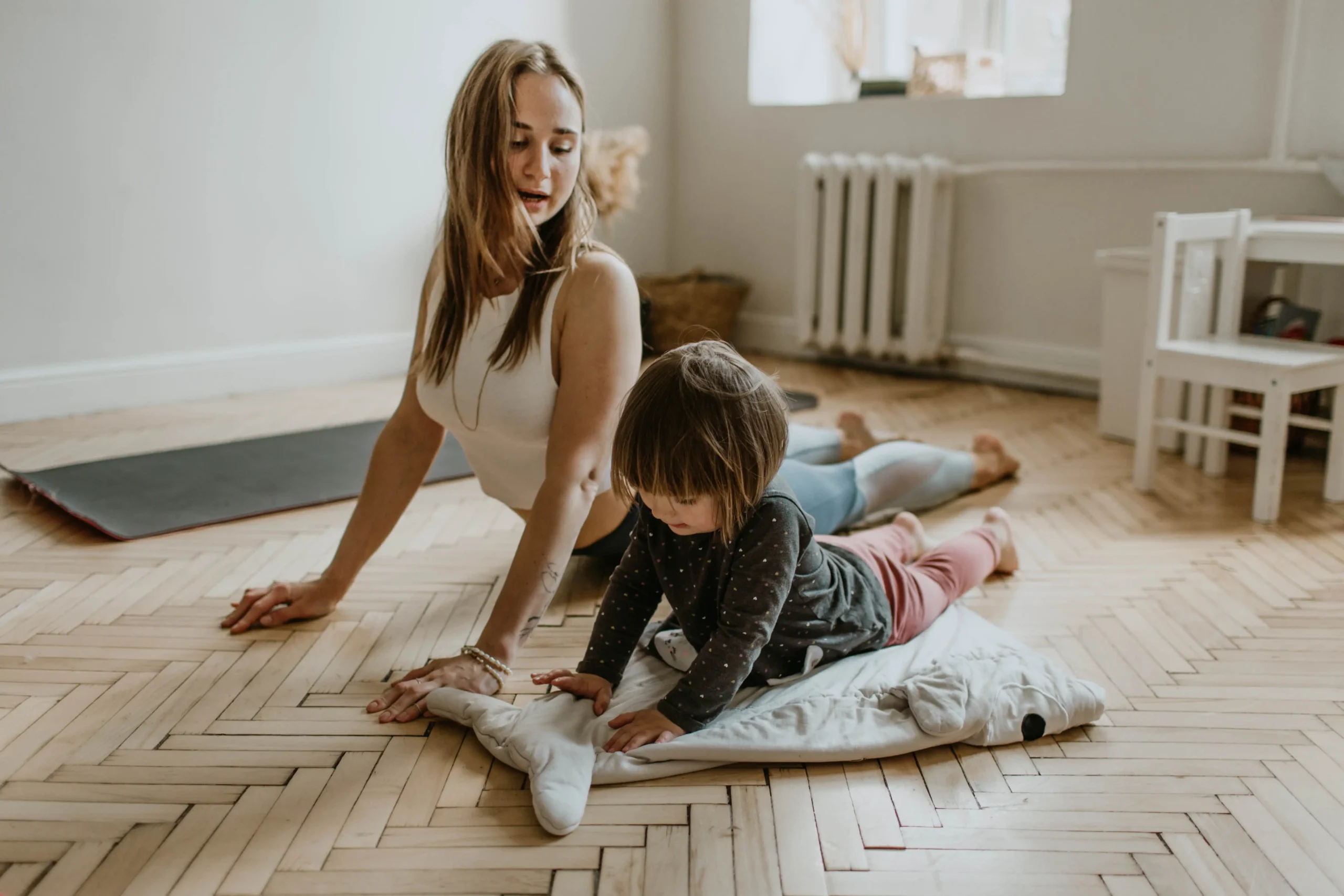 Mother and her baby doing yoga together.