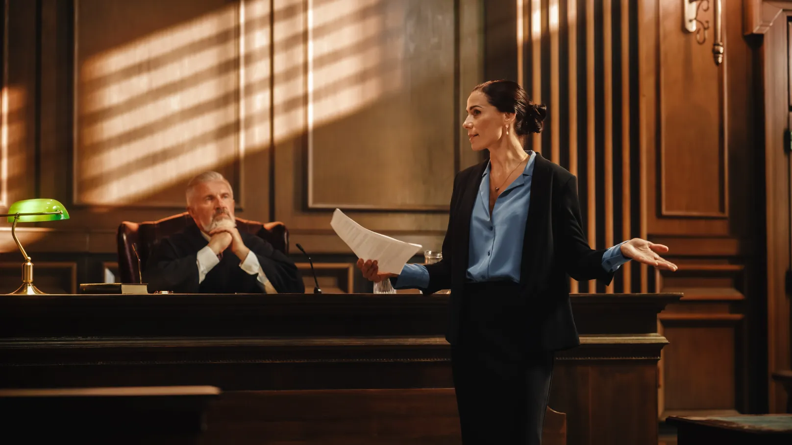 An attorney speaking in a courtroom.