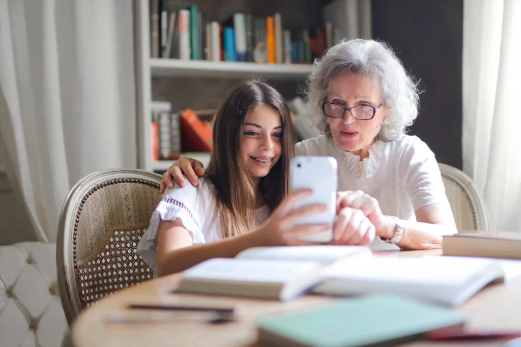 a grand mother and there grand child watching phone