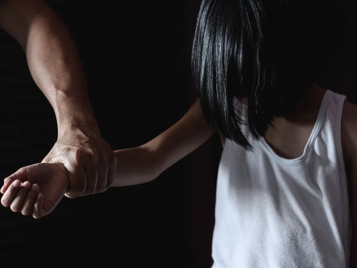 Angry man yanking his spouse by the wrist.