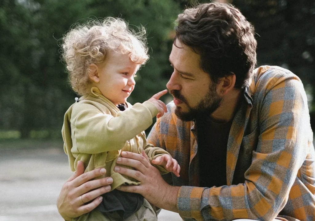 A dad taking care of his young child.