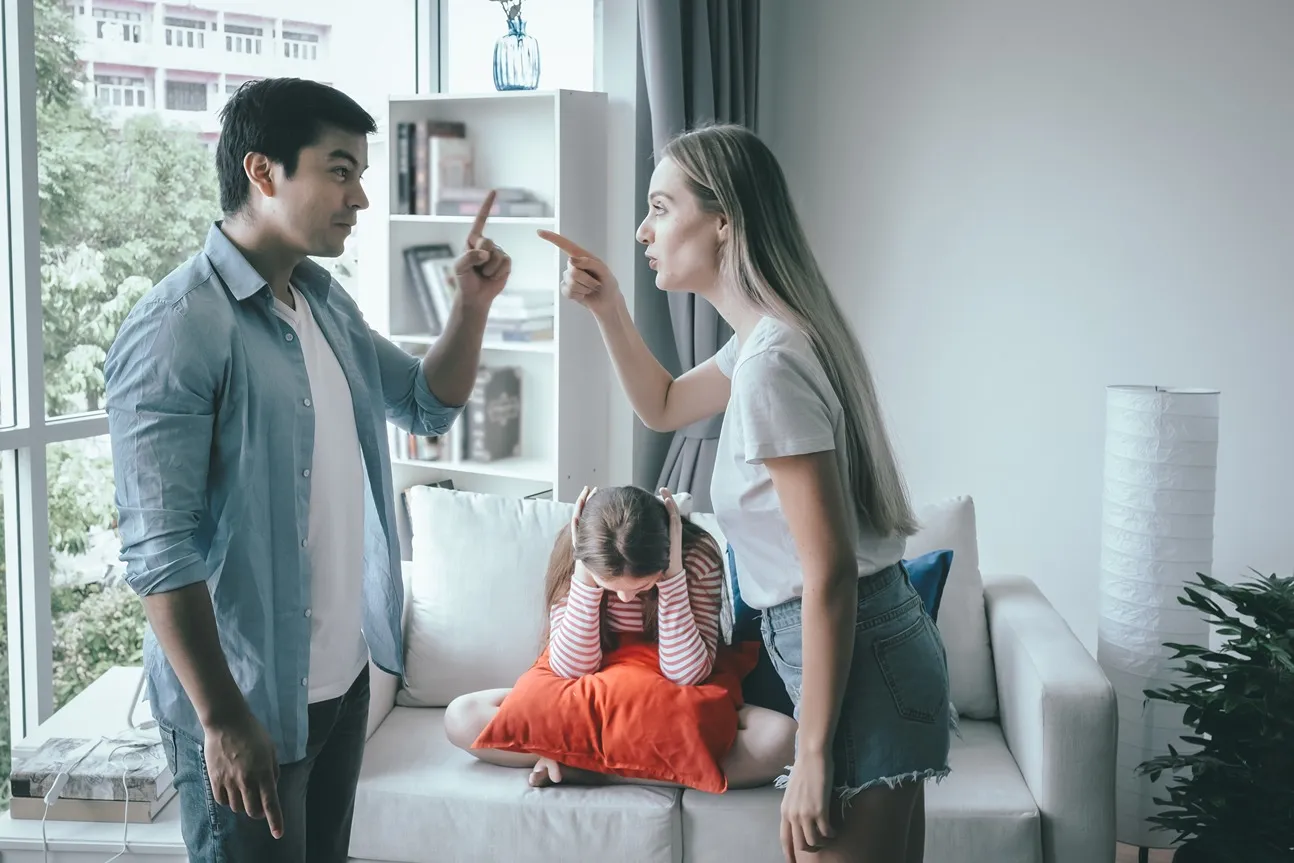 Two parents fighting in front of their daughter.