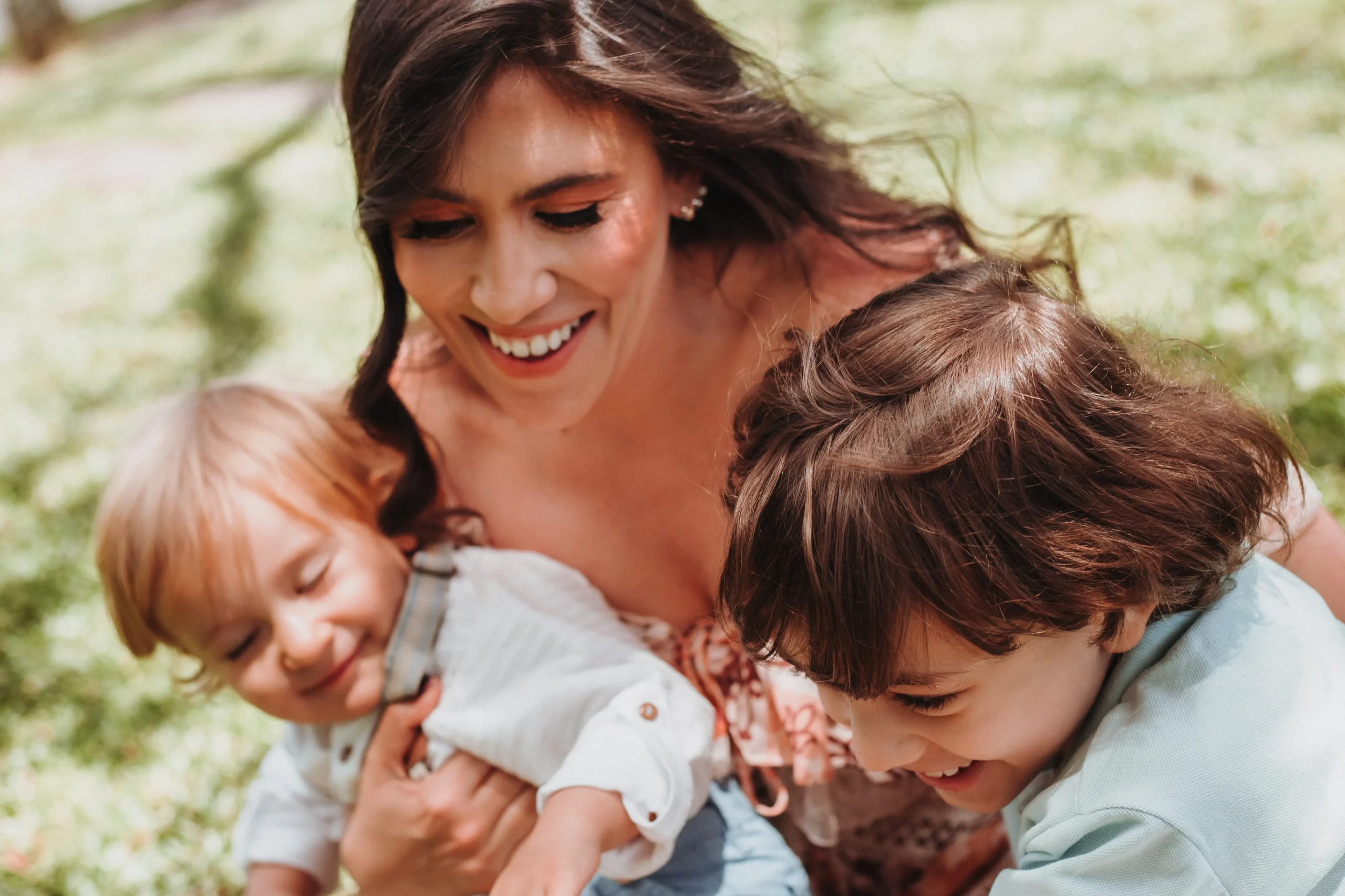 Woman holding her children and laughing.