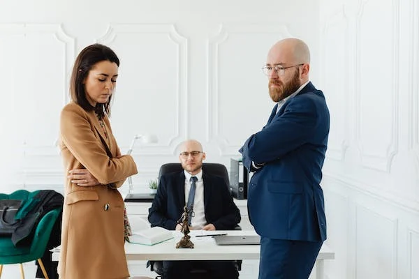 Couple disagreeing with lawyer sitting between them