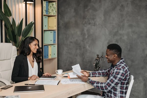 A man sitting and talking to a female lawyer