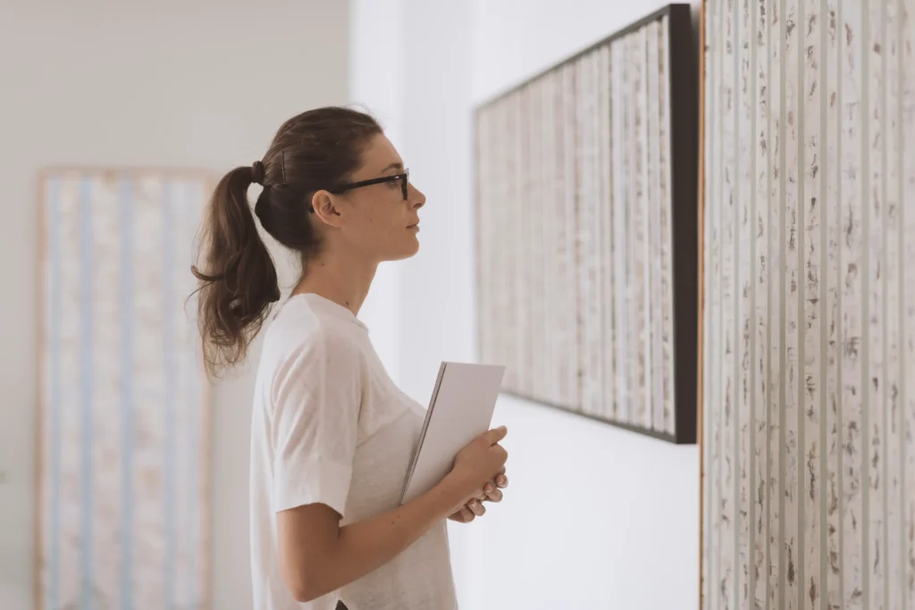 A woman looking at a painting.