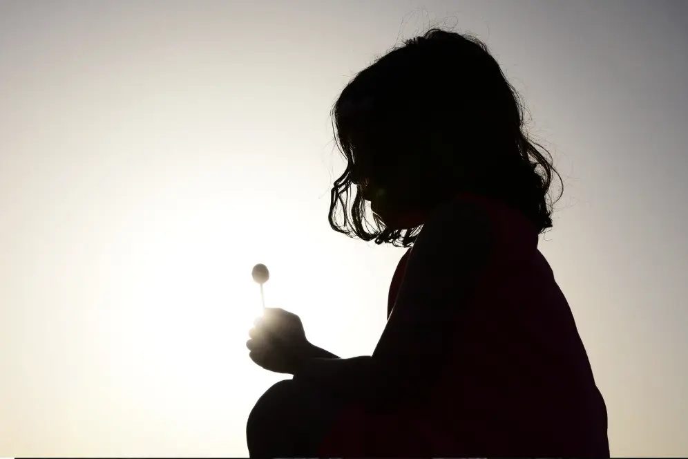 "A sad child sits alone, symbolizing the emotional impact of toxic grandparent relationships.