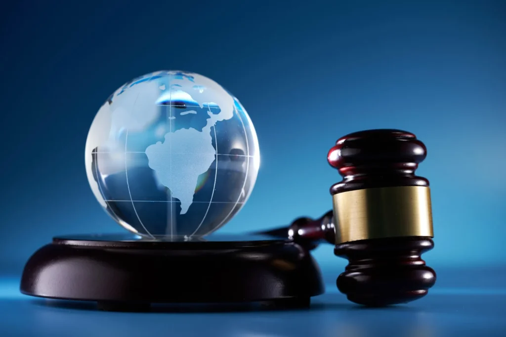 A gavel next to a glass globe, symbolizing legal issues related to international divorce in Sugar Land.